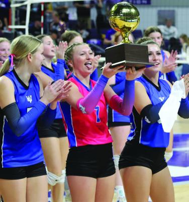 Trojanette Libero Karissa Fillingim lifts the Regional Championship trophy after Windthorst’s 3-1 win over Sterling City in the Regional Finals on Monday, Nov. 10. Photo/Nathan Lawson