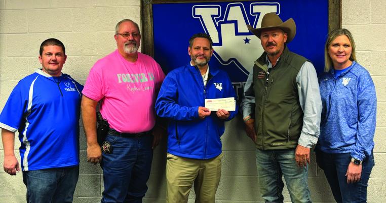 Windthorst ISD accepted a donation of $4,380 to the Kaybree Coleman Scholarship on Friday, Jan. 31. The money was raised from a burger benefit in the fall. Pictured from left to right: Windthorst High School Principal Daniel Williams, Archer County Constable Pct. 2 Donald Stevens, WISD Superintendent Jason Nolan, Justin Coleman and WISD Assistant Superintendent Darla Tackett. Photo/Nathan Lawson