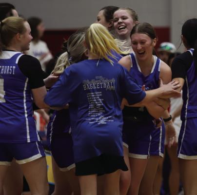 Trojanettes swarm senior Karissa Fillingim during a timeout after the guard nailed a pair of threes and a two-pointer late in fourth quarter in Windthorst’s Bi-District round clash with Anson on Monday, Feb. 16. Photo/Landon Davis