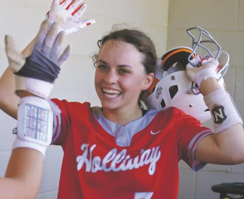 Holliday’s Evelyn Perkins celebrates in the dugout after scoring a run in the first inning of the Lady Eagles’ 4-0 win over then No. 5 Jacksboro on Tuesday, April 6. Photo/Will Edwards