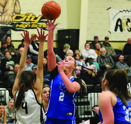 Trojanettes senior Megg Lindley lobs up a shot over Archer City’s Malia Jones in Windthorst’s 52-40 win on Tuesday. Photo/Landon Davis