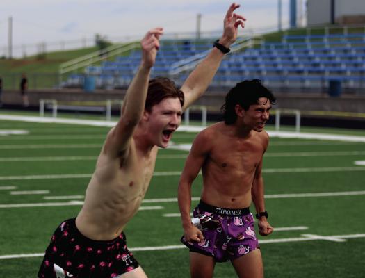 Nolan Schreiber celebrates a rock, paper, scissors victory to claim first over Kolton Rodgers at the finish line of the 45th annual Windthorst Dairy Derby 5k on Sunday, June 1. Photo/Nathan Lawson