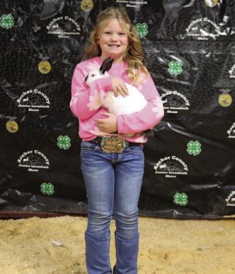 Parish Stubblefield poses with her Grand Champion Rabbit Project. Photo/Nathan Lawson