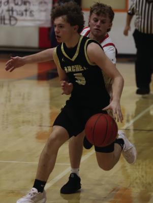 Freshman Wildcat Brayden Tedrow speeds by a Petrolia Pirate in Archer City’s road district win on Tuesday, Feb. 10. Photo/Landon Davis