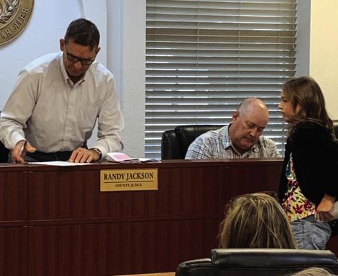 Archer County Judge Randy Jackson signs a proclamation declaring Oct. 6-12 as 4-H week in the county. Photo/Nathan Lawson
