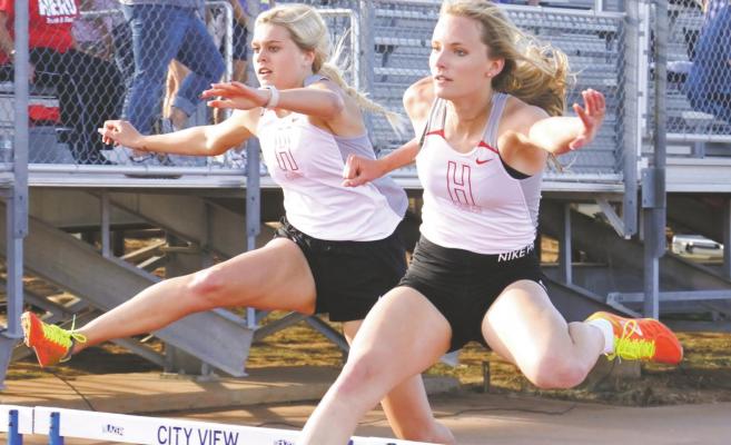 Holliday’s Payton Murray (right) and Grayson Castagna (left) finished first and second in the 300 hurdles, respectively, earning a berth in the area meet. Photo/Will Edwards