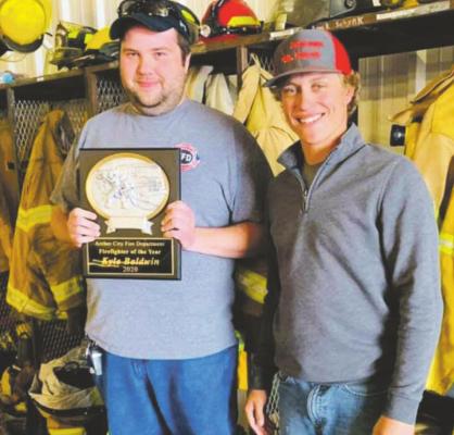 ACVFD fireman of the year Kyle Baldwin and ACVFD Chief Kelvin Green pose for a photo with Baldwin's plaque on Sunday, March 21. Courtesy photo