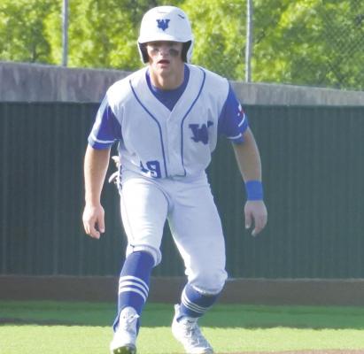 Windthorst senior Ethan Belcher takes a look at the plate from third in the Trojans’ 12-4 win over Cooper in the area round on Thursday, May 13, at Denton Ryan. Photo/Will Edwards