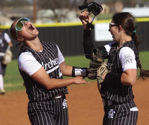 Archer City's Addi Canada (left) and Adelyn Winter (right) celebrate after Canada made an inning ending catch in the outfield against Petrolia on March 11. Photo/Nathan Lawson