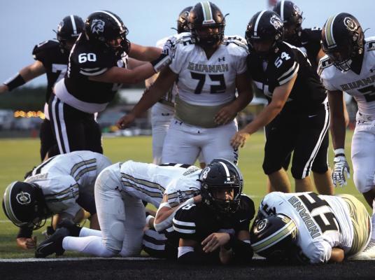 Wildcat Senior Running Back Cason Booher waits on a call after he reached for the goal line. He was marked short but ran it in on the next play. Photo/Nathan Lawson