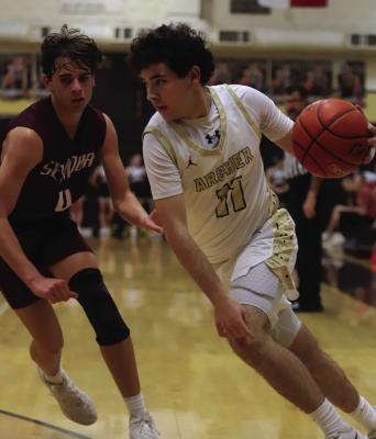 Wildcat post Grayson Jeter dribbles by a Panther defender in Archer City’s home game against Seymour on Tuesday, Feb. 17. Photo/Landon Davis