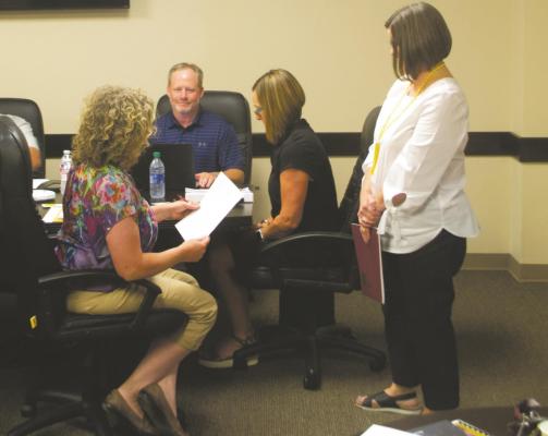 Jill Dunkel (left) is sworn into the Archer City ISD School Board by Business Manager Bridgette Wylie during its meeting Monday, Aug. 31. Photo/Nathan Lawson