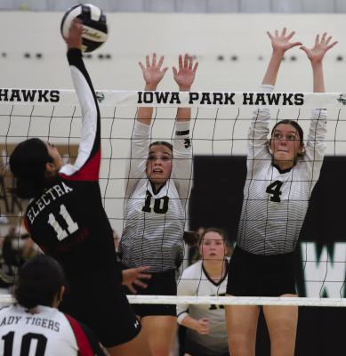 Freshman Millie Mayo and senior Malia Jones brace for a block in the Lady Cat’s Bi-District playoff volleyball matchup against the Electra Lady Tigers. Photo/Landon Davis
