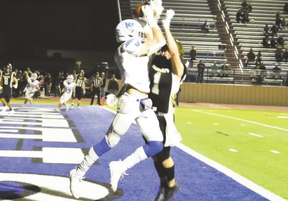 Windthorst’s Kyle Wolf pulls down his second touchdown catch of the night on a 14-yard pass from Cy Belcher as Archer City’s Callen McCasland tries to break up the pass. The Trojans defeated the Wildcats 42-7 in their area round matchup in Graham on Friday, Nov. 20. Photo/Will Edwards