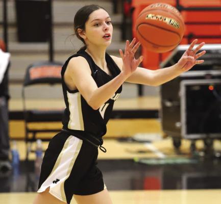 Archer City's Malia Jones looks for a teammate during the Lady Cats 62-23 loss to Burkburnett.