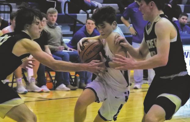 Windthorst’s Max Owen fights through a double team in the second half of the Trojans’ 69-64 loss to Archer City in the season finale on Tuesday, Feb. 9. Photo/Will Edwards