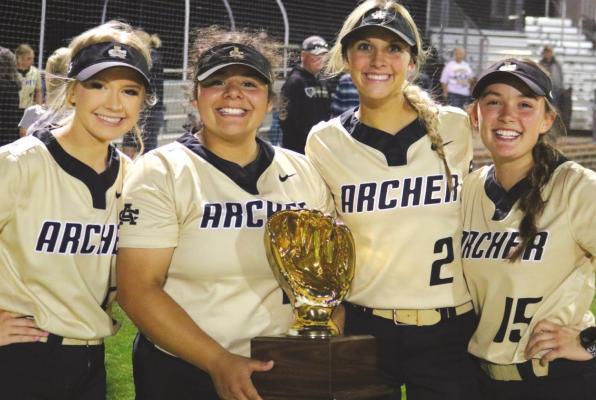 Archer City’s seniors Sara Kyle, Maddie Lopez, Mallory Maxwell and Aspyn Huseman pose with the bi-district championship trophy after sweeping the doubleheader with Era on Thursday, April 28, in Springtown. Photo/Jerry Phillips
