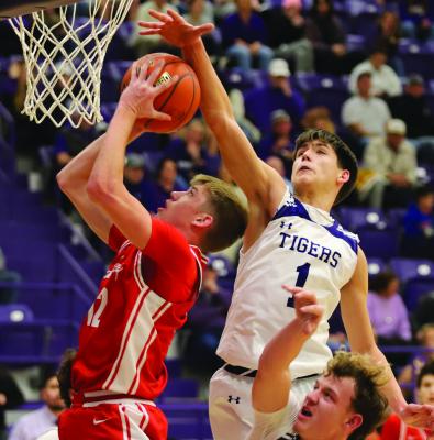 Eagle post Preston Fandler fights through two Tiger defenders for a layup in Jacksboro on Friday, Jan. 16. Photo/Landon Davis