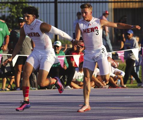 Holliday’s first leg in the 4x100 relay Crue Harrison hands off the baton to second leg Brayden Hamill at the regional meet in Abilene on Saturday, May 1. Photo/Landon Davis