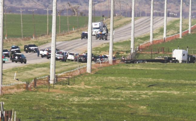 Law enforcement surrounds an 18-wheeler occupied by Kelly Joe Cearley during a multiple hour stand-off after a high speed chase through four counties. Photo/Jerry Phillips