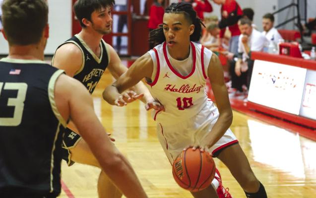 Holliday’s Keitenn Bristow drives the lane in the first quarter of the Eagles’ 60-28 win over Henrietta on Tues., Jan. 10. Photo/Will Edwards
