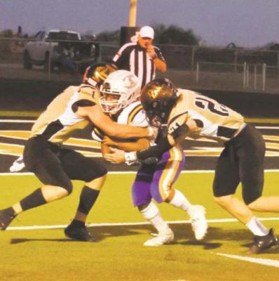 Seniors Callen McCasland and Layne Briggs tackle the Munday ballcarrier for a loss in the first quarter of Archer City’s 61-0 win over Munday on Thursday, Oct. 22 Photo/Will Edwards