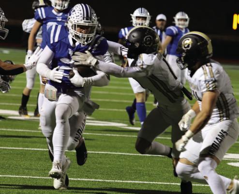 Senior Trojan Cash Armstrong fights his way through Quanah defenders in Windthorst’s 62-14 Bi-District win on Thursday, Nov. 14. Photo/Jerry Phillips