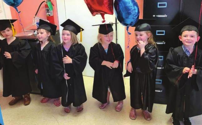 Archer City Head Start graduates L-R: Madison Ball, Emory Richey, Brynlee Kolacek, Mckinley White, Charles Gulley and Azley White prepare to walk to get their diplomas at the graduation ceremony Thursday, May 19. Courtesy photo