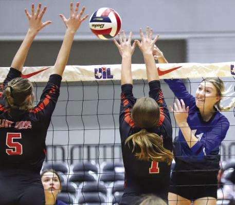 Rylee Wolf spikes a kill between a pair of Schulenberg defenders in the second set of the Trojanettes 3-1 win over the Lady Horns in the Wednesday’s state semifinal match. Photo/Will Edwards