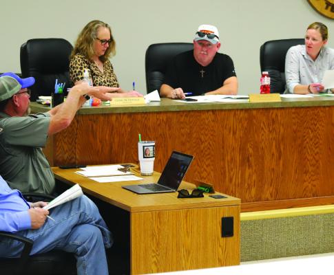 Holliday Public Works Director Danny Addison presents the S. Main Street and S. West Street sewer lift station project to the city council. Photo/Landon Davis