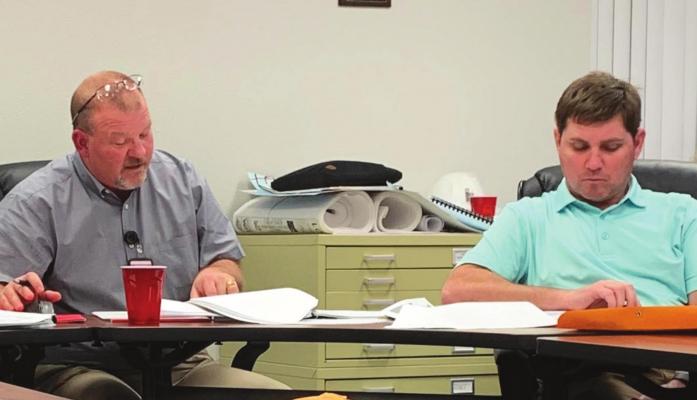 Holliday Superintendent Cody Carroll (left) presents the state of the distric report as board member Eric Morris listens on. The district also purchased two busses during the meeting. Photo/Nathan Lawson