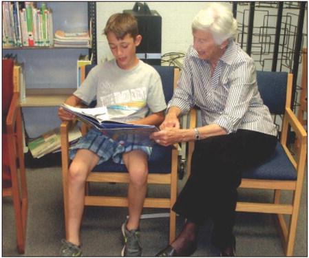 Fern Starnes reads with her Book Buddy each week during school in 2018. Archer City ISD is looking for Book Buddies for the 2024-2025 school year. File photo