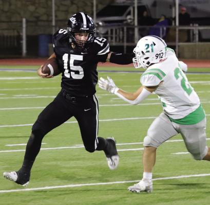 Freshman quarterback Seth Truette stiff-arms a Shamrock defender in the Wildcat’s Bi-District round playoff game h in Childress on Thursday, Nov. 14. Photo/Landon Davis
