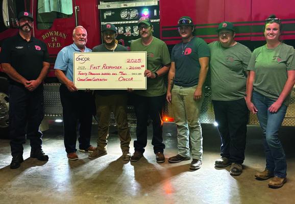 Oncor's Gordon Drake presents a $20,000 check to the Bowman Volunteer Fire Department as part of the Oncor Cares Grant Foundation. Courtesy photo