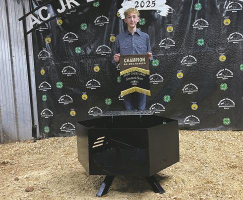 Ty Cantrell poses with his grand champion ag mechanics project. Photo/Nathan