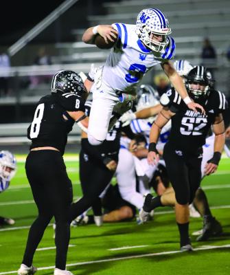 Windthorst quarterback Brock Belcher gets caught mid air by a Lindsay defender on a hurdle attempt in the Trojans' 30-27 Area round win on Friday, Nov. 22. File photo