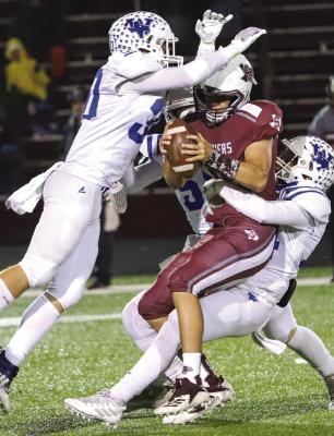 Windthorst’s Tyler Camacho, Jorge Moreno and Drew Anderle bring down Seymour’s Keegan Gilbreath in the first quarter of the Trojans’ 20-13 loss to the Panthers on Friday, Oct. 28. Photo/Will Edwards