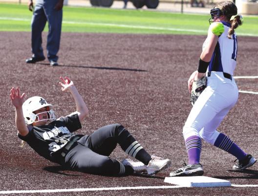 Archer City’s Vivian Rater slides into third ahead of the throws in the Lady Cats 5-4 loss to Jacksboro on Thursday, March 3, in Iowa Park. Photo/Will Edwards