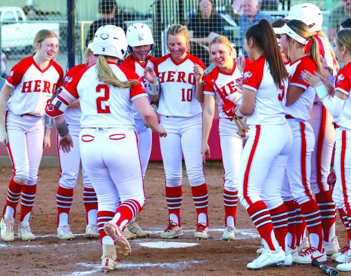 Holliday's Kinley Marek is greeted by her teammates at the plate following a home run in the Iowa Park Tournament. Photo/Will Edwards