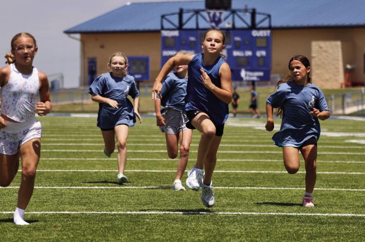 The nine and 10-year-old girls race to the finish during the Dairy Derby Children's Races as part of the St. Mary's Parish Picinic. Courtesy photo/Kenda Schroeder Wolf