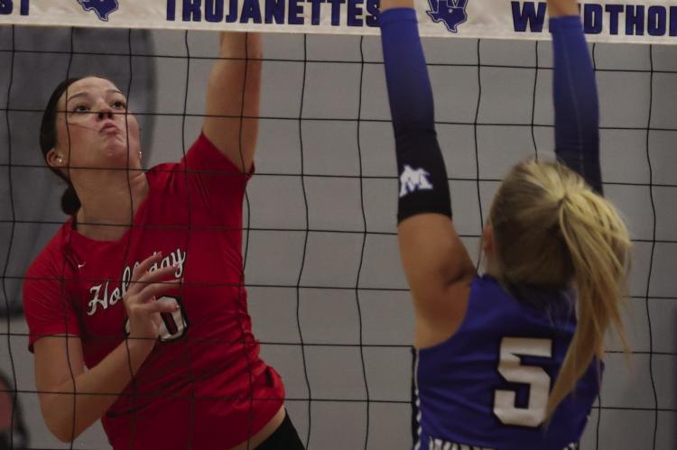 Holliday's Caitlyn Leggett looks to get a kill attempt past Windthorst's Jaylee Belcher in the Lady Eagles 3-1 win over the Trojanettes on Tuesday, Sept. 15. Photo/Rolando Medina