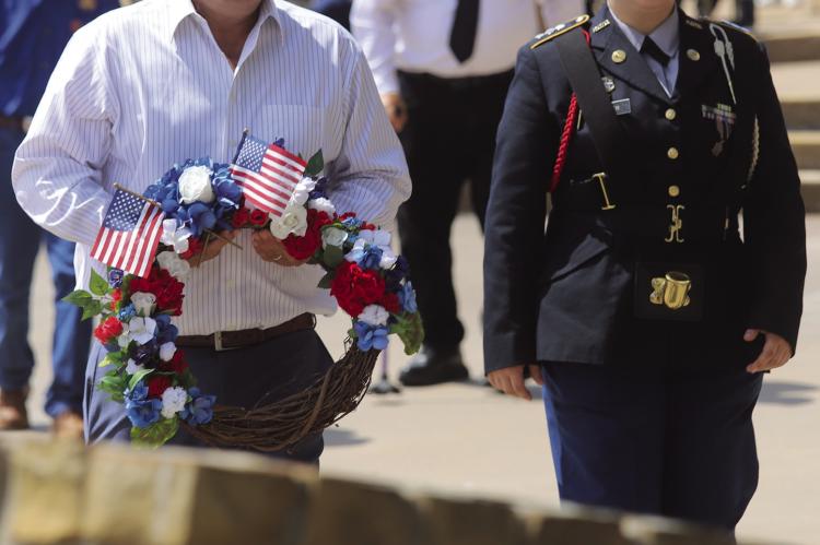 Aaron Blake, Nephew of Marine Corporal Leo Blake, prepares to lay a wreath at his uncle's memorial as part of the Windthorst Memorial Day ceremonies. Photo/Nathan Lawson