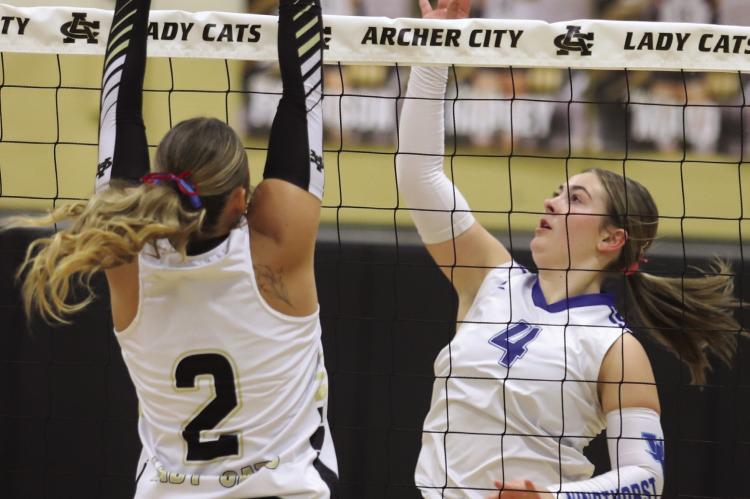 Windthorst Sophomore Haddy Steinberger looks for a kill over Archer City's Senior Addi Canada in the Trojanette's 3-0 win over the Lady Cats on Tuesday, Sept. 29. Photo/Rolando Medina