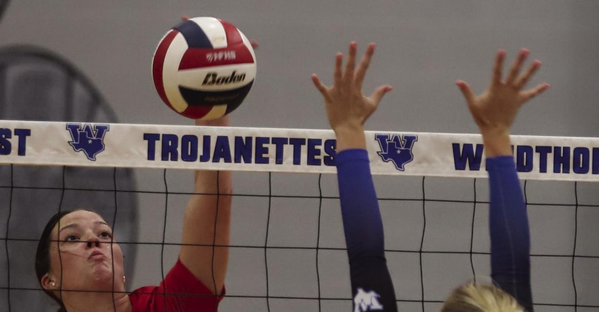 Holliday's Caitlyn Leggett looks to get a kill attempt past Windthorst's Jaylee Belcher in the Lady Eagles 3-1 win over the Trojanettes on Tuesday, Sept. 15. Photo/Rolando Medina