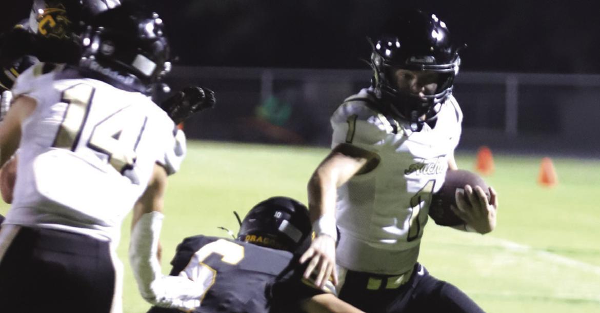 Archer City Sophomore Brayden Tedrow runs past a Dragon defender on his way to a third quarter touchdown in the Wildcats 28-7 win. Photo/Rolando Medina