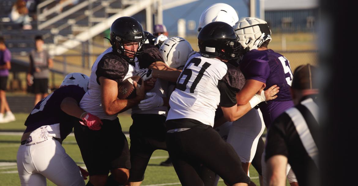 The Archer City Wildcats saw their first action of the season as they scrimmaged the Roscoe Plowboys at home on Friday, Aug. 14. Pictured is Wildcat Quarterback Seth Truette squeezing into the endzone for Archer City's first touchdown of the evening. Photo/Nathan Lawson