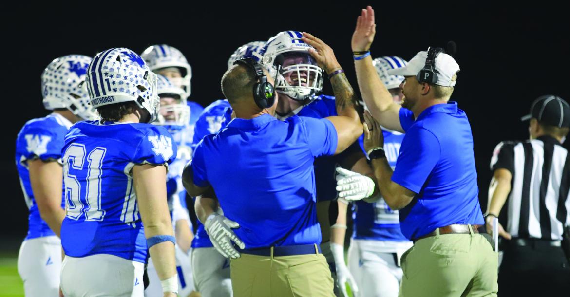 Trojans Defensive Coordinator Juan Cavazos embraces Rodie Yearian after the senior came up with an interception for the Trojans in their 72-34 win over Haskell on Friday, Oct. 23. Photo/Rolando Medina